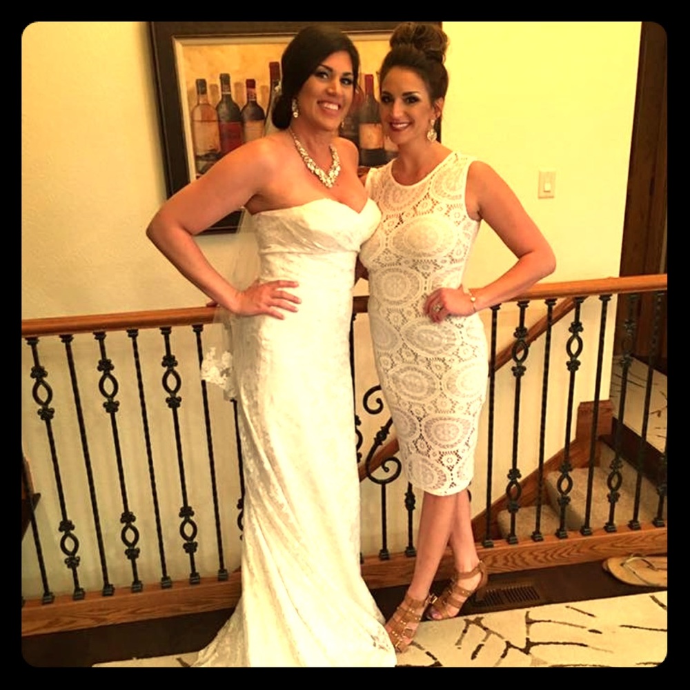 Off white lace dress with a tan bodice underneath.